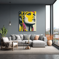 Modern living room with a gray sofa, decorative pillows, and a colorful abstract painting on the wall.