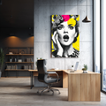 Modern office interior with a large portrait of a woman on the wall.