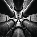 Black and white photo of multiple pipes converging at a central point